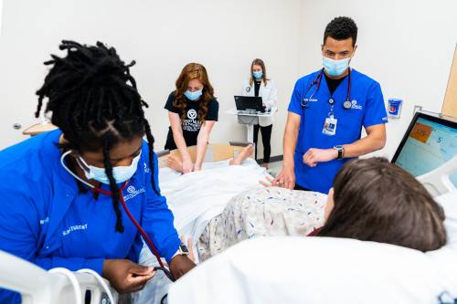 Students working with a standardized patient.